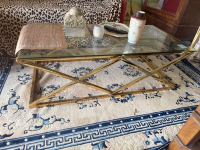 a coffee table with a glass top sitting on a rug