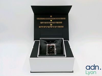 an image of a box with a watch inside of it on a white surface