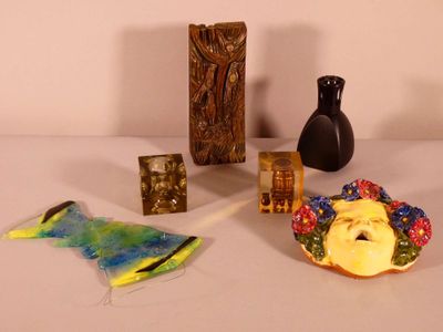 a table with various items on it including a vase, a bird, and a statue