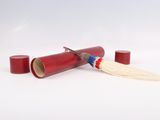 a red tube with a toothbrush and a tooth brush on it