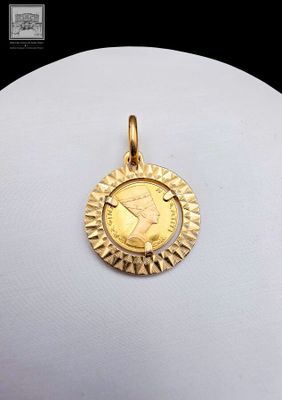 a close up of a gold coin on a white mannequin