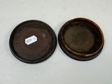 two brown bowls with a tag on them sitting on a white surface