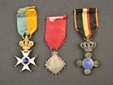 three medals and a medal are sitting on a table
