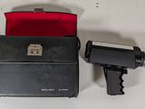 a black camera and a red case sitting on a table