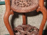 a wooden chair that has a basket on top of it