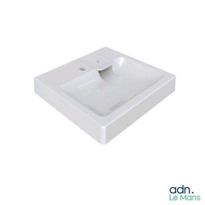 the white sink is sitting on top of the white counter