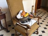 a chair with a bowl of fruit on it in a room