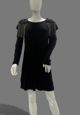 an image of a mannequin wearing a black dress with fringes