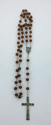 a rosary with a cross on it sitting on a table