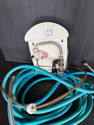 a close up of a blue hose connected to a white electrical outlet