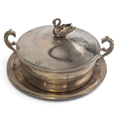 a silver plate with a swan on it on a white surface