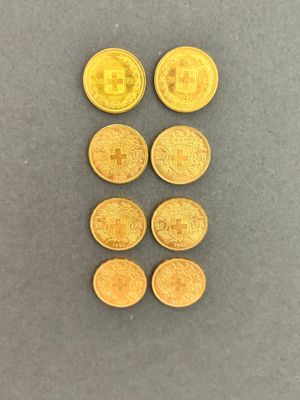 a close up of a bunch of gold coins on a table