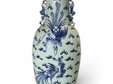 a blue and white vase sitting on a white surface