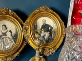 three framed pictures of a man and a woman on a shelf