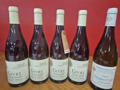 six bouteilles de vin sont alignées sur une table en bois