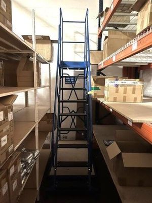 a ladder in the middle of a room with boxes on the shelves
