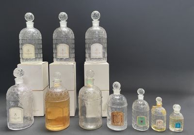 several bottles of different types and sizes of perfumes on a table