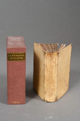 two books sitting next to each other on a gray surface