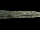 a close up of a very old metal object on a black background