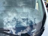 a reflection of the sky in the windshield of a car