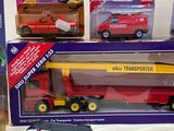 three toy cars and a toy truck in the box