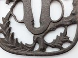 a metal object with a bird on it on a white surface