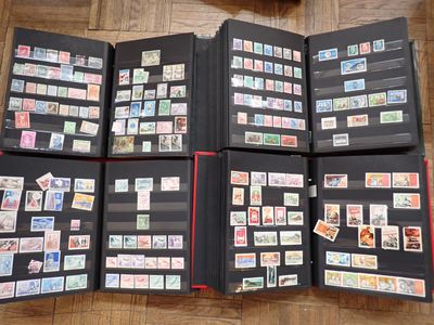 a lot of stamps in a folder on the floor