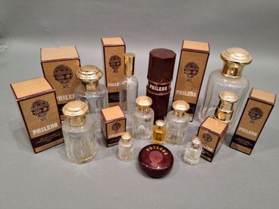 several bottles of perfume sitting on top of a table next to boxes of perfume