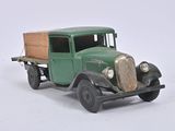 a green toy truck with a wooden box on the back of it