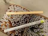 many rolls of toilet paper and a baseball bat in a cardboard box