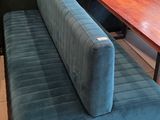 a bench and a table in the corner of a restaurant