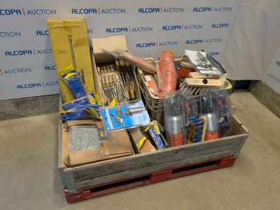 a wooden box filled with assorted items in front of a wall
