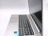 a laptop computer sitting on a white surface