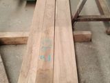 several pieces of wood are stacked on top of each other in a warehouse