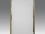 a large mirror with a wooden frame and a white background