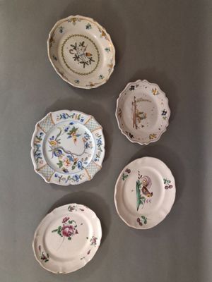 several plates are arranged in a row on a table