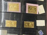 a lot of gold and silver stamps on a black box