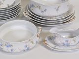 a lot of plates and bowls that are sitting on a table