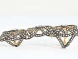 a close up of a pair of black and white diamond cuff bracelets