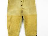 an old pair of yellow pants with buttons and buttons on them