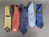 four different colored ties are lined up in a row on a table