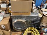 a pile of boxes and other items in a warehouse