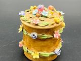 a small yellow box with flowers on it on a table