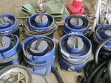 a lot of blue buckets and hoses on the floor
