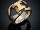 a close up of a ring with a gold cross on it