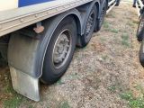 a blue and white truck that is parked in the grass