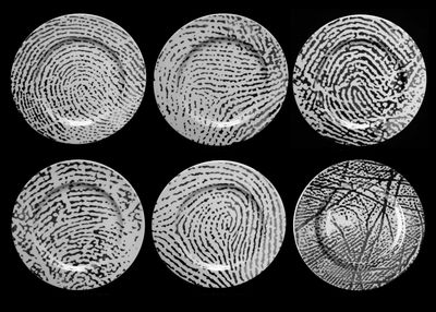 four different types of fingerprints on a black background