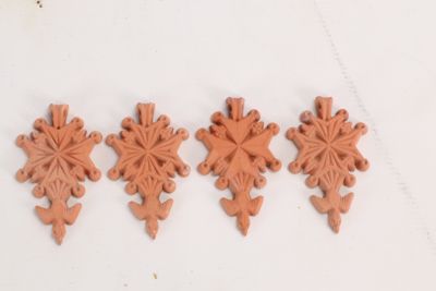 four pieces of clay are arranged in a row on a white surface