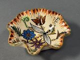 a small bowl with a design of flowers on it