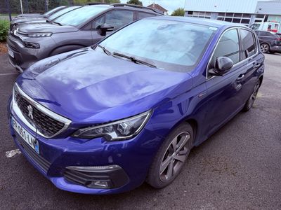 a blue car that is parked in a parking lot